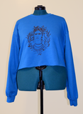 turquoise sweatshirt with screen printed artwork of Frida Kahlo on the Front 